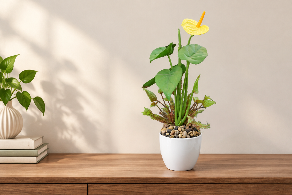Wide console table scene with faux yellow anthurium plant