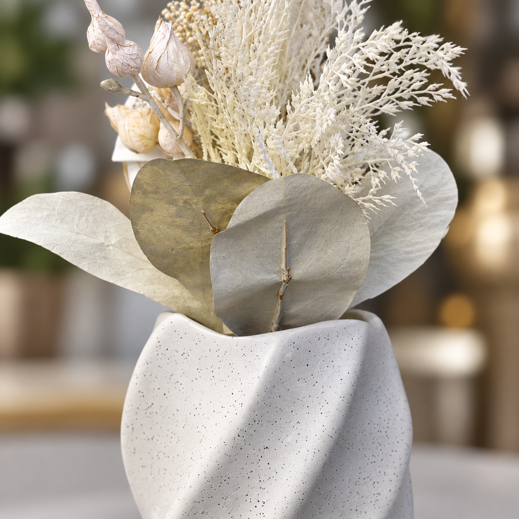 Close-up of vase texture and dried floral stems