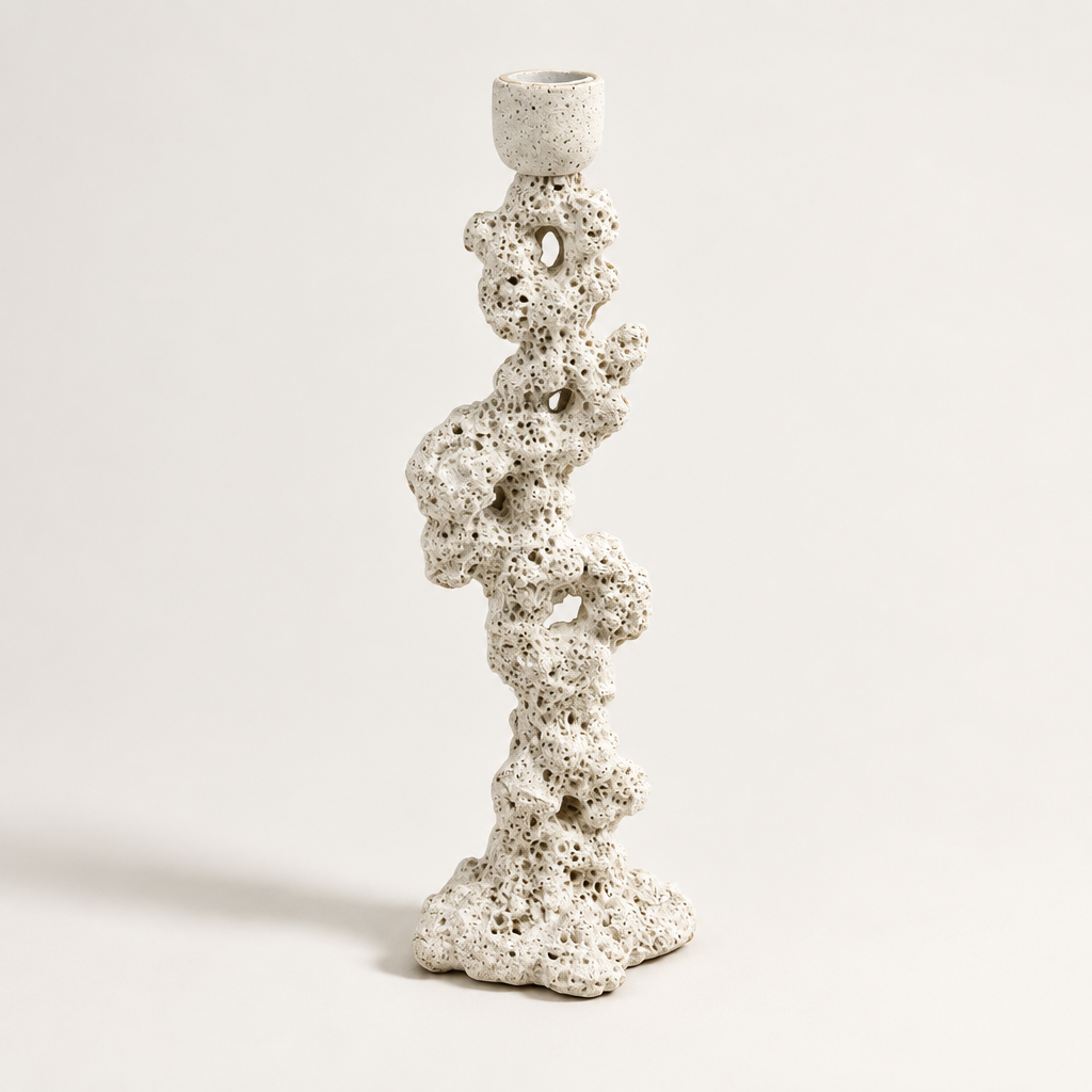Off-white coral rock candlestick on a clean studio background