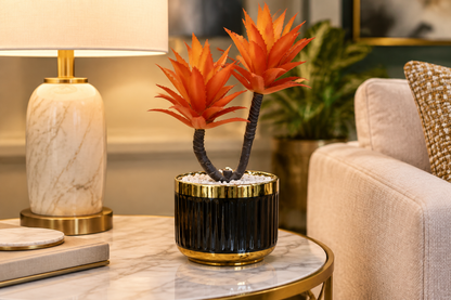 Faux orange aloe succulent planter on a marble side table