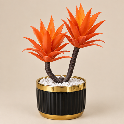 Faux orange aloe succulent in black and gold ceramic planter, three-quarter angle