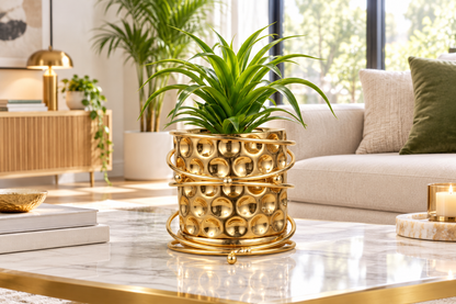 Gold planter with green plant in living room